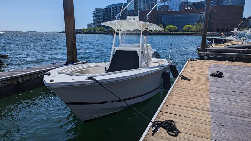 Slide: The Image of 2017 Regulator 23 boat docked by waterfront with cityscape background. - 11