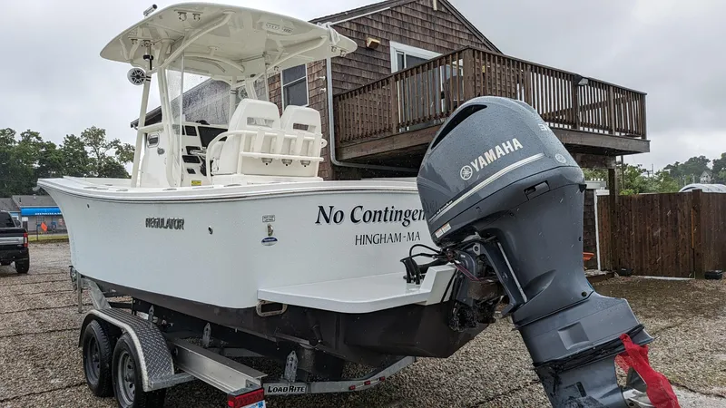Slide: The Image of 2017 Regulator 23 boat with Yamaha motor on trailer, parked outdoors. - 15