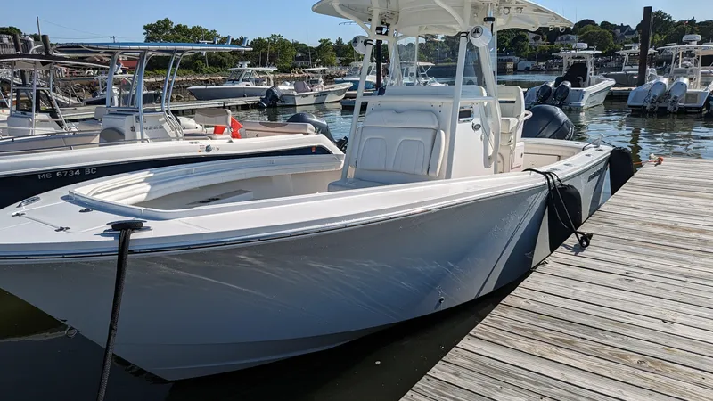 Slide: The Image of 2017 Regulator 23 boat docked at marina on a sunny day. - 16