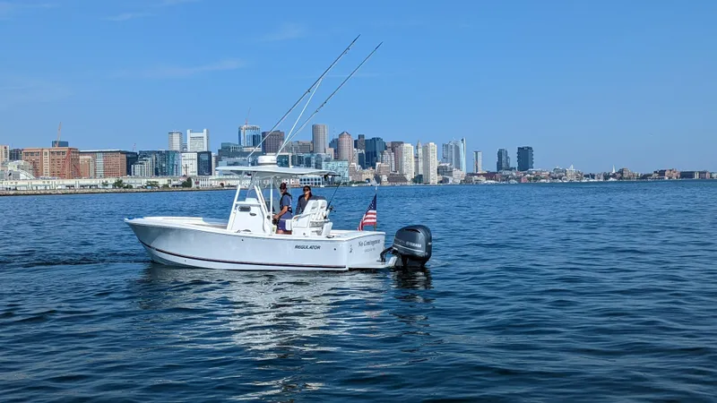 Slide: The Image of 2017 Regulator 23 boat on water with city skyline in background. - 6