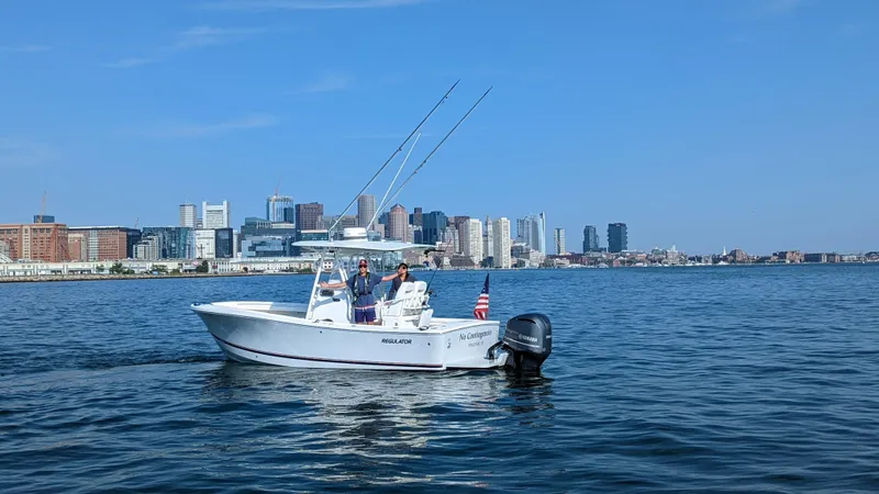 Slide: The Image of 2017 Regulator 23 boat on water with city skyline in background. - 7