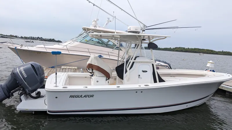 Slide: The Image of 2017 Regulator 23 boat docked with Yamaha outboard motor. - 9