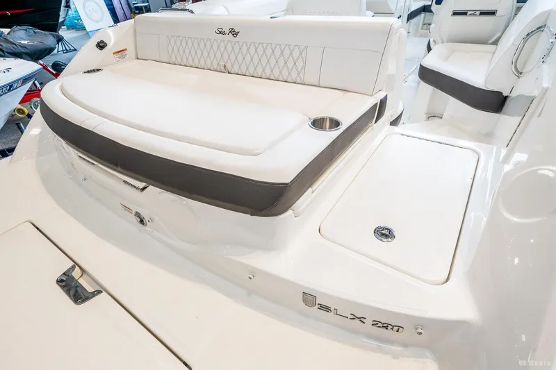 Slide: The Image of 2020 Sea Ray 230SLX boat interior with white seating and cup holders. - 13