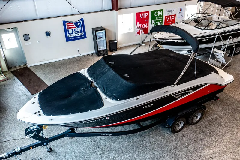 Slide: The Image of 2020 Sea Ray 230SLX boat in showroom, covered and on trailer. - 15