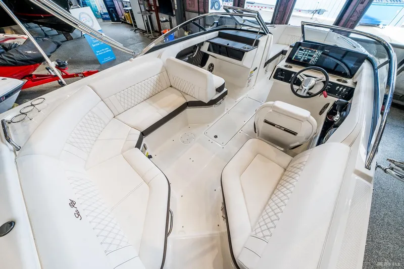 Slide: The Image of 2020 Sea Ray 230SLX boat interior with luxurious white seating and modern dashboard. - 18