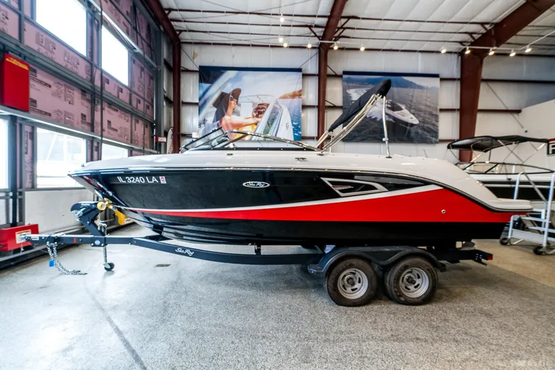 Slide: The Image of 2020 Sea Ray 230SLX boat on trailer in indoor showroom. - 2
