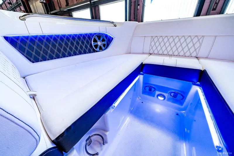 Slide: The Image of 2020 Sea Ray 230SLX interior with blue LED lighting and luxurious seating. - 26