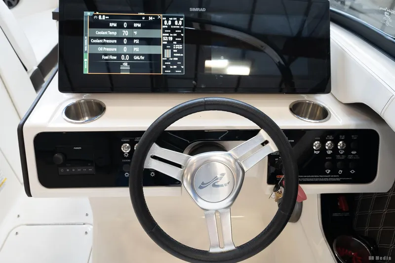 Slide: The Image of 2020 Sea Ray 230SLX boat dashboard with steering wheel and digital display. - 33