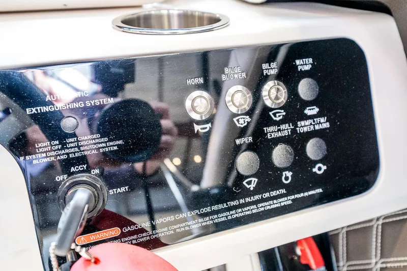Slide: The Image of Control panel of a 2020 Sea Ray 230SLX boat with various switches and warning label. - 36
