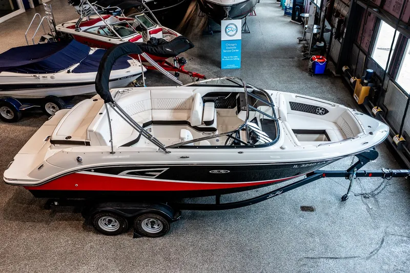 Slide: The Image of 2020 Sea Ray 230SLX boat on trailer in showroom, featuring sleek design and modern amenities. - 5