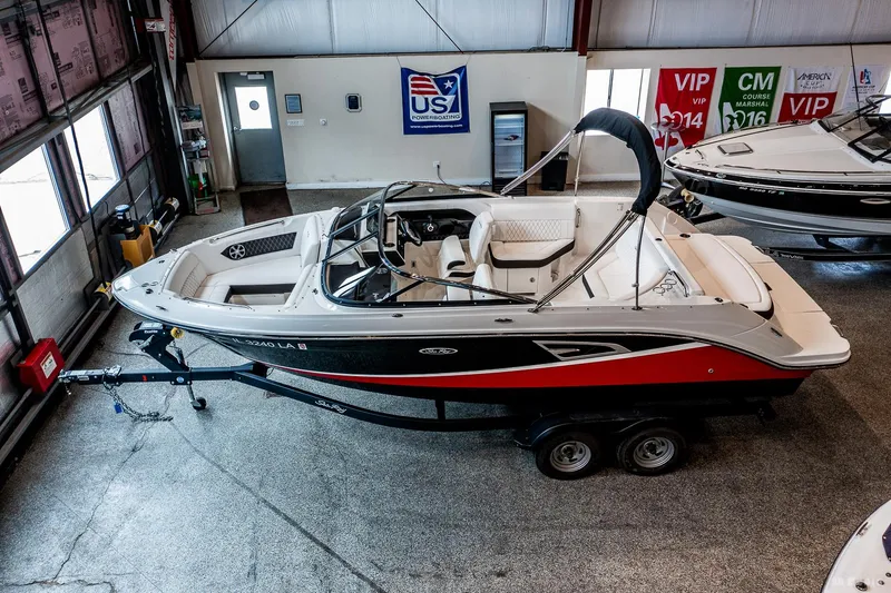 Slide: The Image of 2020 Sea Ray 230SLX boat on trailer in showroom, side view. - 8