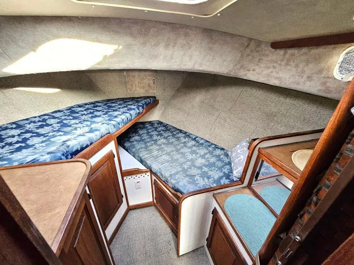 Slide: The Image of 1978 Mainship 34 Sedan cabin interior with twin beds and wooden cabinetry. - 12