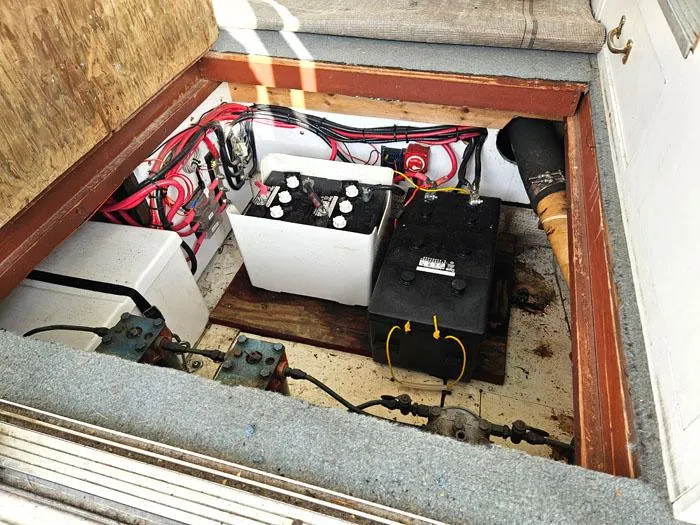 Slide: The Image of 1978 Mainship 34 Sedan engine compartment with batteries and wiring. - 15