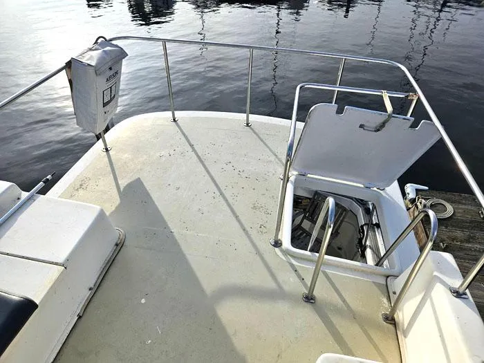 Slide: The Image of 1978 Mainship 34 Sedan boat deck with open hatch and safety railings. - 18