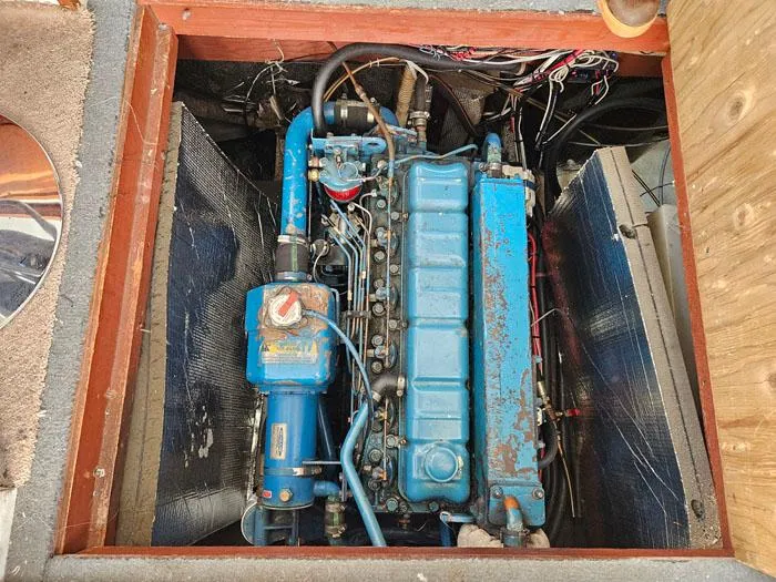 Slide: The Image of 1978 Mainship 34 Sedan engine compartment with visible blue engine components. - 19