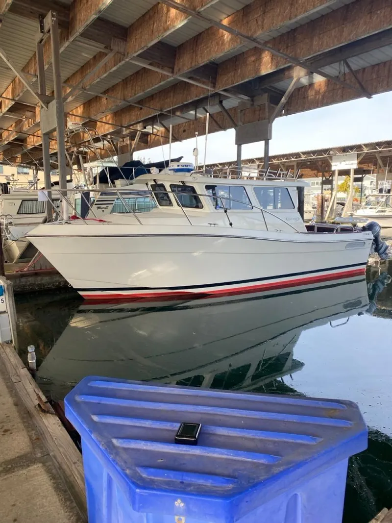 Slide: The Image of 2005 Ocean Sport Roamer 30 boat docked under a covered marina. - 2