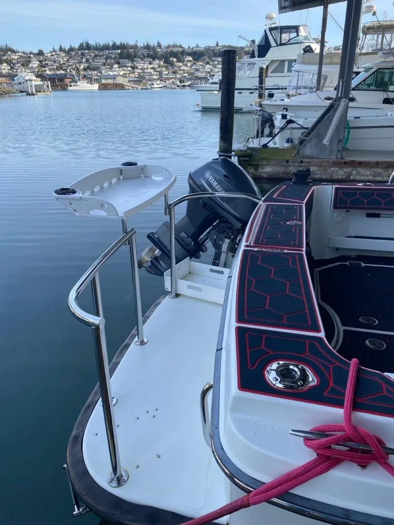 Slide: The Image of 2005 Ocean Sport Roamer 30 docked, featuring sleek design and Yamaha outboard motor. - 3