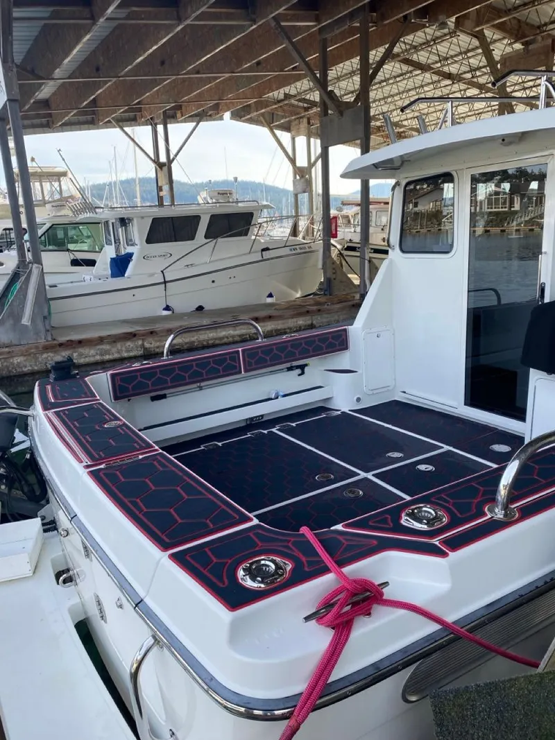 Slide: The Image of 2005 Ocean Sport Roamer 30 boat docked under a covered marina. - 4