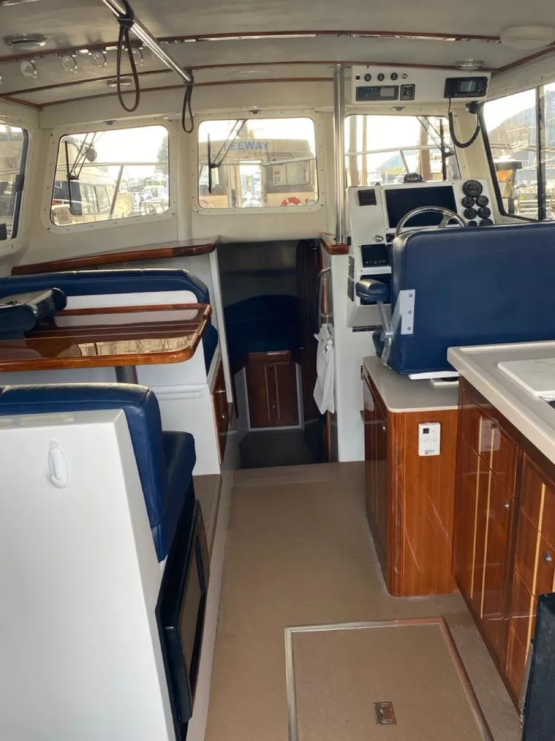 Slide: The Image of Interior of a 2005 Ocean Sport Roamer 30 boat with seating and navigation area. - 7