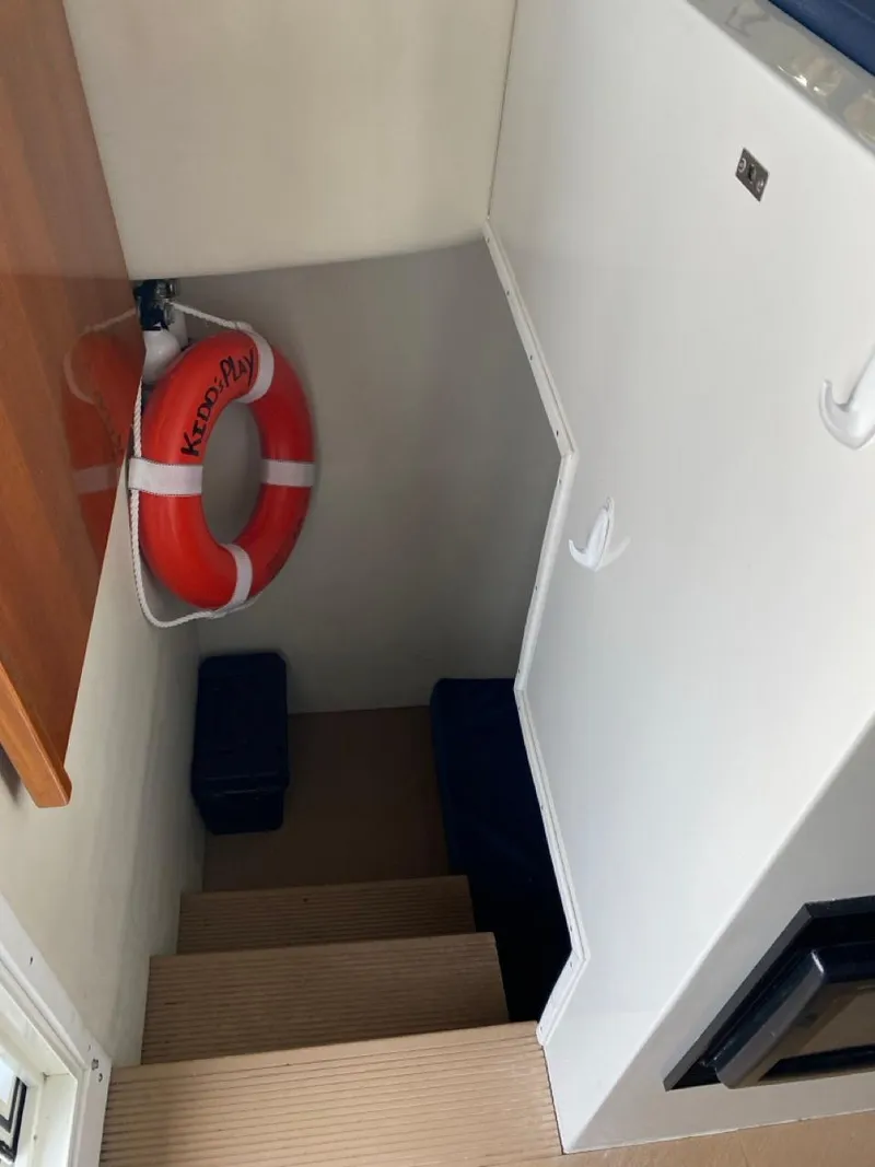 Slide: The Image of Interior stairs of 2005 Ocean Sport Roamer 30 with life preserver on wall. - 8