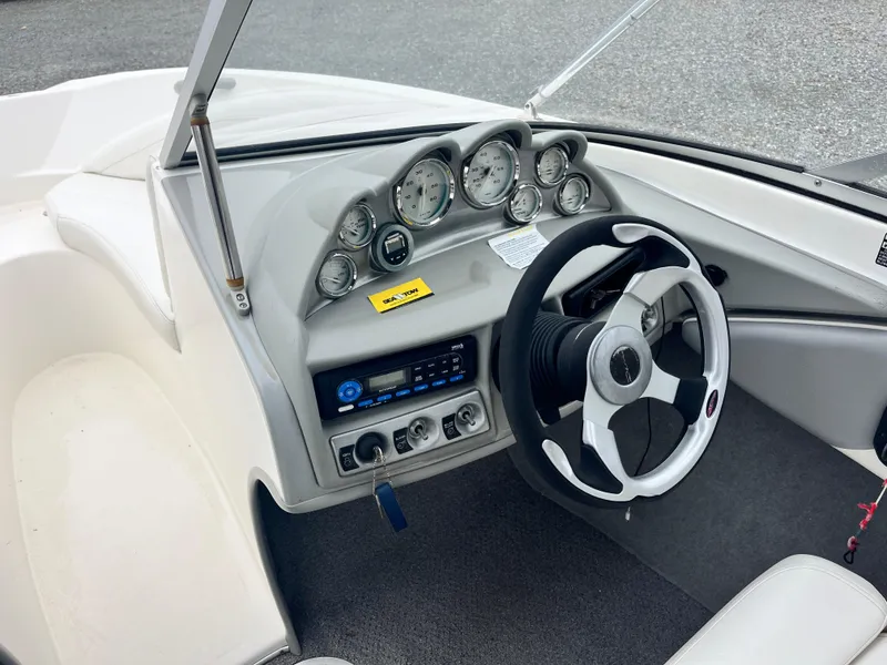 Slide: The Image of 2009 Bayliner 185 boat dashboard with steering wheel and instrument panel. - 11