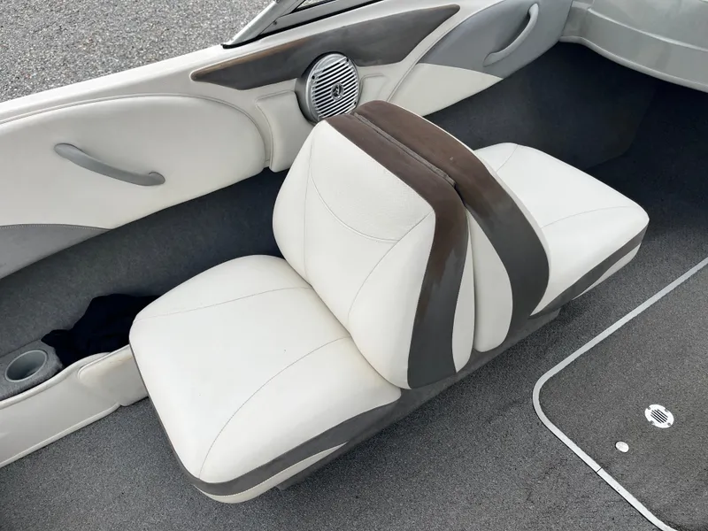 Slide: The Image of 2009 Bayliner 185 boat interior with white and gray seating. - 16