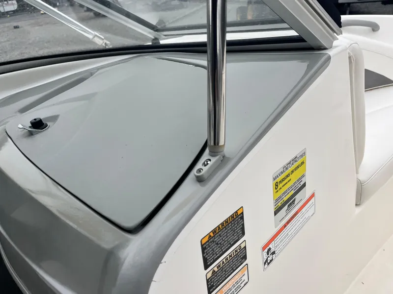 Slide: The Image of 2009 Bayliner 185 boat dashboard with safety labels and windshield detail. - 18
