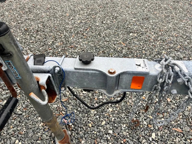 Slide: The Image of Trailer hitch of a 2009 Bayliner 185 on gravel surface. - 5