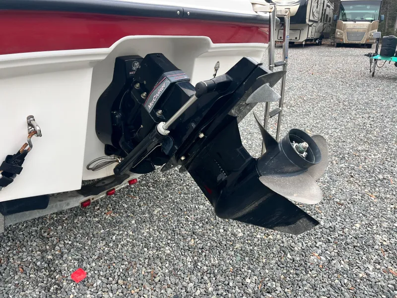 Slide: The Image of 2009 Bayliner 185 boat with outboard motor on gravel surface. - 7