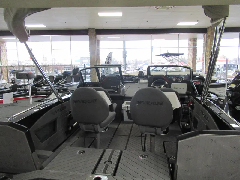 Slide: The Image of 2025 Vexus DVX20S boat interior in showroom, featuring seating and dashboard. - 4