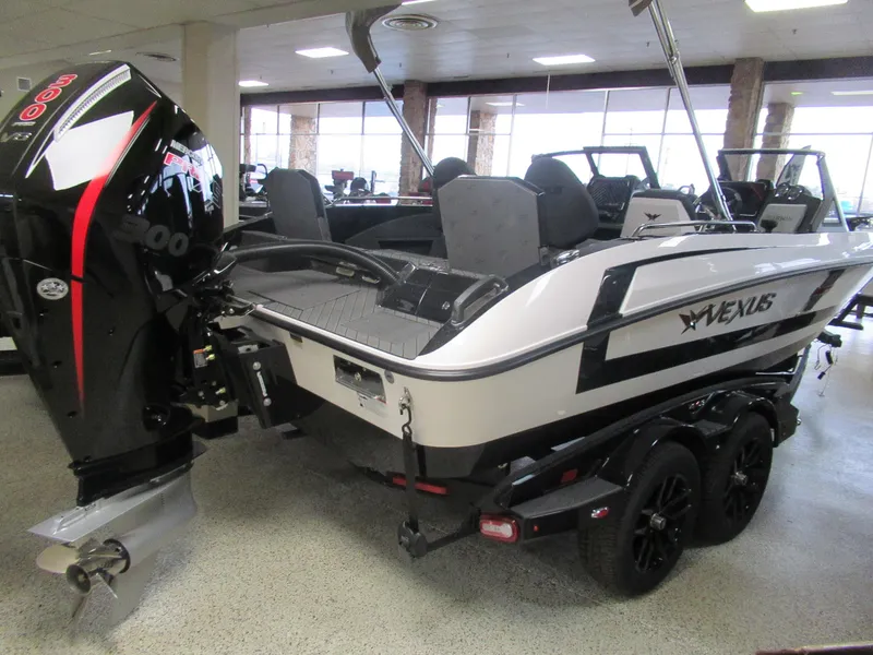 Slide: The Image of 2025 Vexus DVX20S boat with powerful outboard motor in showroom display. - 7