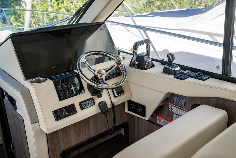 Slide: The Image of 2021 Regal 38 XO helm with modern controls and navigation equipment. - 1