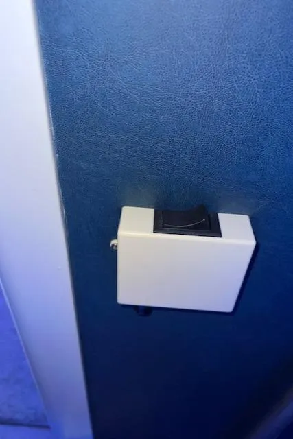 Slide: The Image of Wall-mounted light switch on blue textured surface. - 15