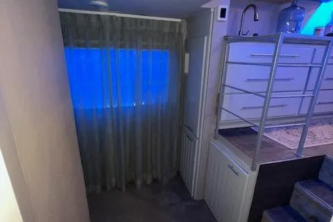 Slide: The Image of Narrow interior space with blue-lit window, modern cabinetry, and stairs. Gibson Standard 1977. - 25