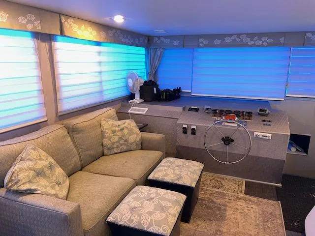 Slide: The Image of 1977 Gibson Standard boat interior with cozy seating and helm, featuring blue-lit windows. - 28