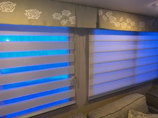 Slide: The Image of Modern window blinds with blue lighting and floral valance design. - 32
