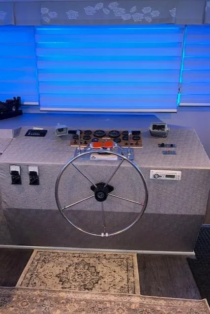 Slide: The Image of Control panel of a 1977 Gibson Standard boat with steering wheel and gauges. - 38