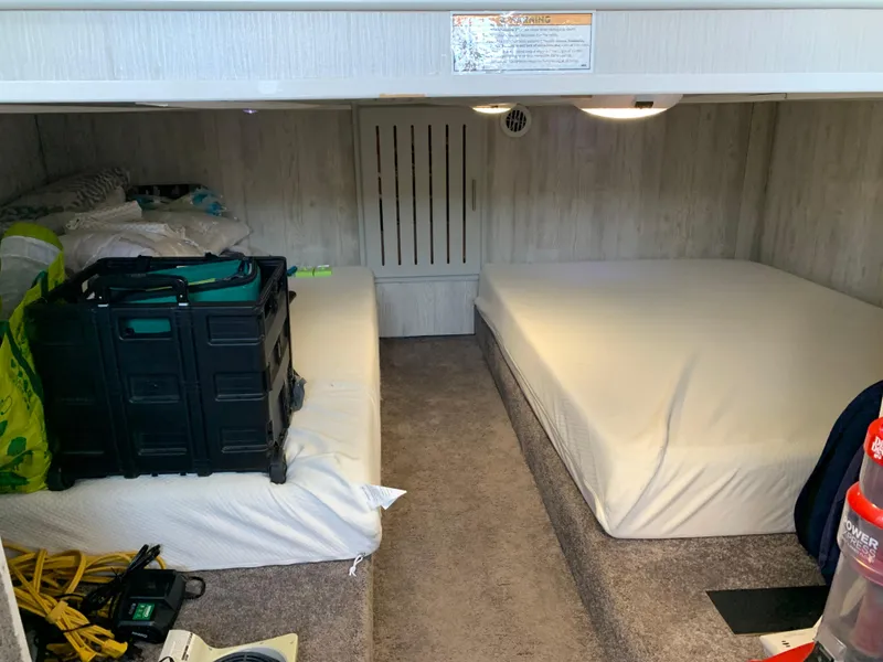 Slide: The Image of 1977 Gibson Standard interior with twin beds, storage boxes, and carpeted flooring. - 4