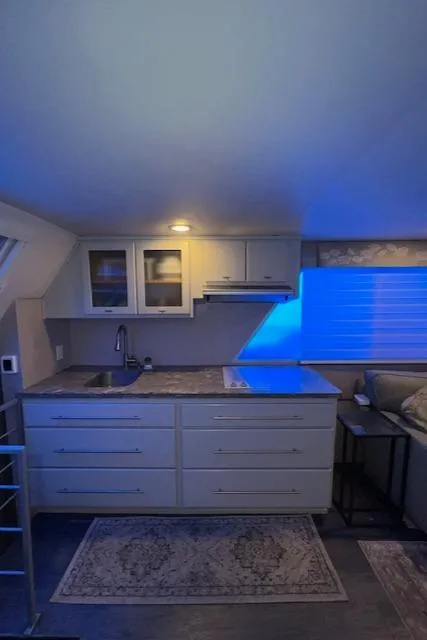 Slide: The Image of Compact kitchen area in a 1977 Gibson Standard boat, featuring modern cabinetry and ambient lighting. - 42