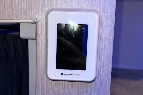 Slide: The Image of A Honeywell Home thermostat mounted on a textured wall. - 44