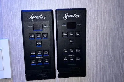 Slide: The Image of Two SkipperLiner control panels for cooling and heating systems on a textured wall. - 45