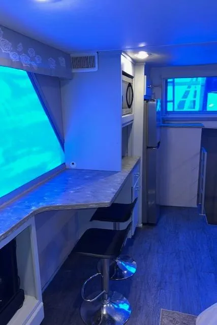 Slide: The Image of Modern interior of a 1977 Gibson Standard boat with blue lighting and sleek furnishings. - 46