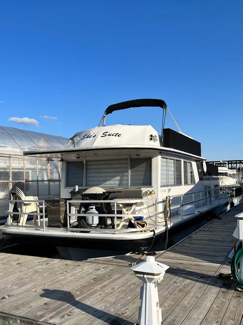 Slide: The Image of 1977 Gibson Standard houseboat docked under clear blue sky. - 5
