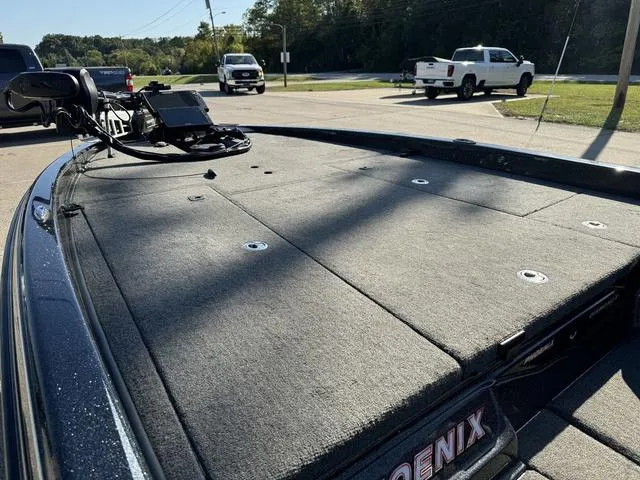 Slide: The Image of 2021 Phoenix 921 ELITE boat deck with mounted equipment, parked outdoors. - 17