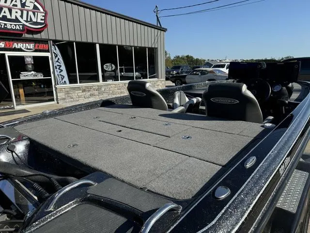 Slide: The Image of 2021 Phoenix 921 ELITE boat at dealership, showcasing spacious deck and seating. - 4