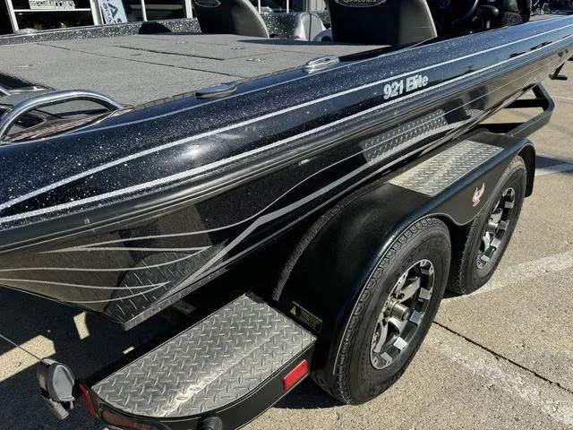 Slide: The Image of 2021 Phoenix 921 ELITE boat on trailer, featuring sleek black design and dual axles. - 5