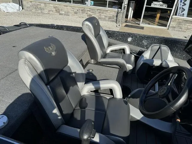 Slide: The Image of 2021 Phoenix 921 ELITE boat interior with gray and black seating, steering wheel, and console. - 6