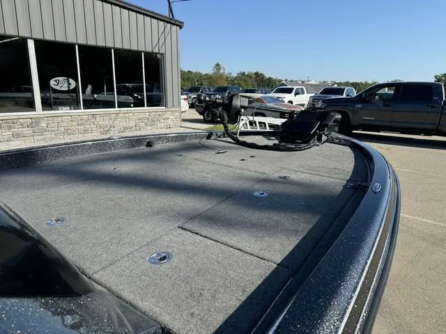 Slide: The Image of 2021 Phoenix 921 ELITE boat deck in a parking lot, near a building and vehicles. - 7