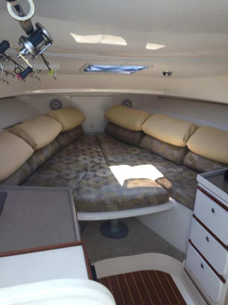 Slide: The Image of 2004 Stamas 310 Express cabin interior with cozy seating and storage. - 4