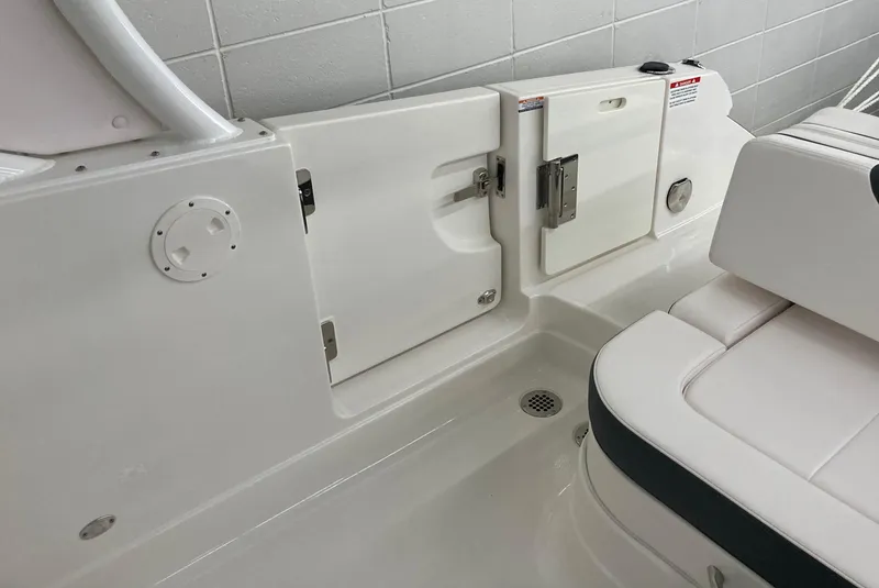 Slide: The Image of 2020 Chaparral 280 OSX boat interior with white seating and storage compartments. - 10